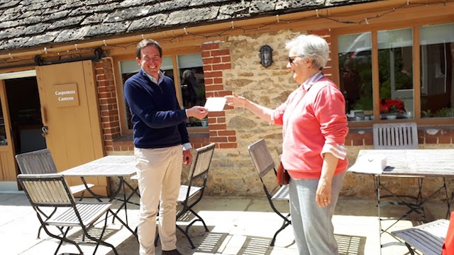 Pauline Martin presenting funds for saplings to Christian Walker at Coleshill estate.